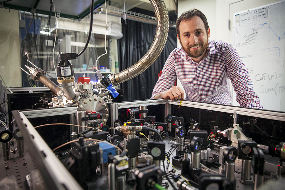 David Moore with his tabletop experiment at Stanford University. | Peter DaSilva for Quanta Magazine