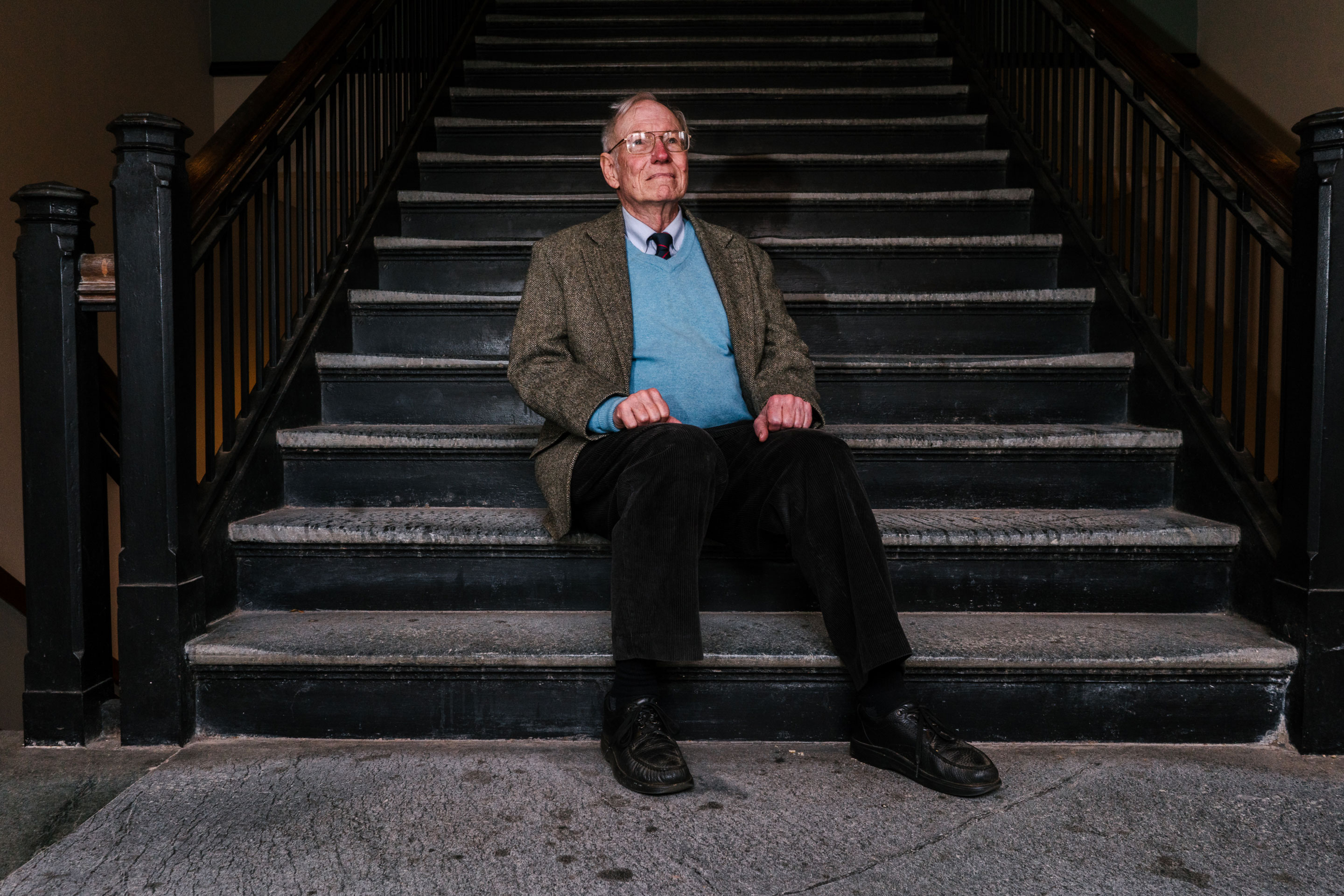 Dr. Jason Morgan, a geophysicist, poses for a portrait in Guyot Hall, home of the geosciences department at Princeton University. He has since retired and moved to Boston, where he is a visiting scholar at Harvard. The steps in the stairwell are made of Serpentine rock, which is formed in the Earth's mantle.