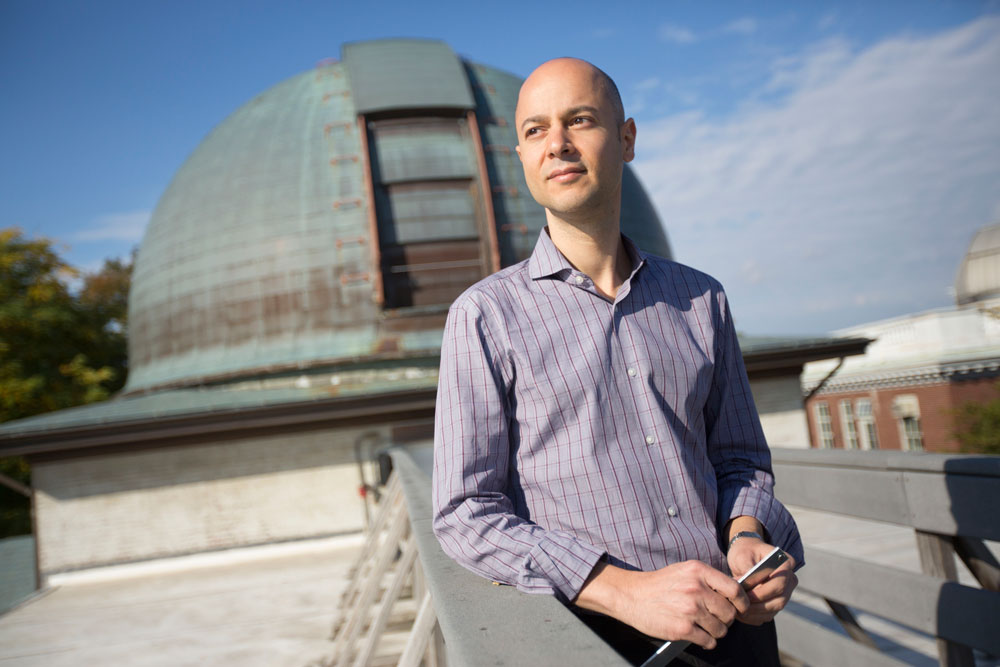 Edo Berger in front of a domed building on a nice day