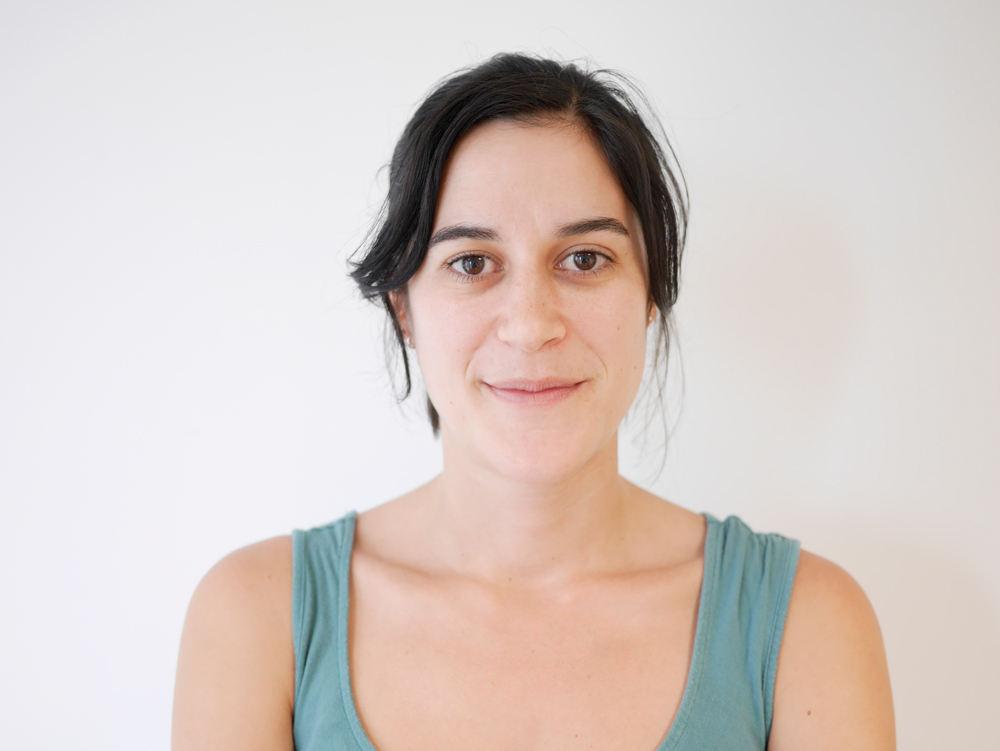 Emília Santos against a white background wearing a blue tank top