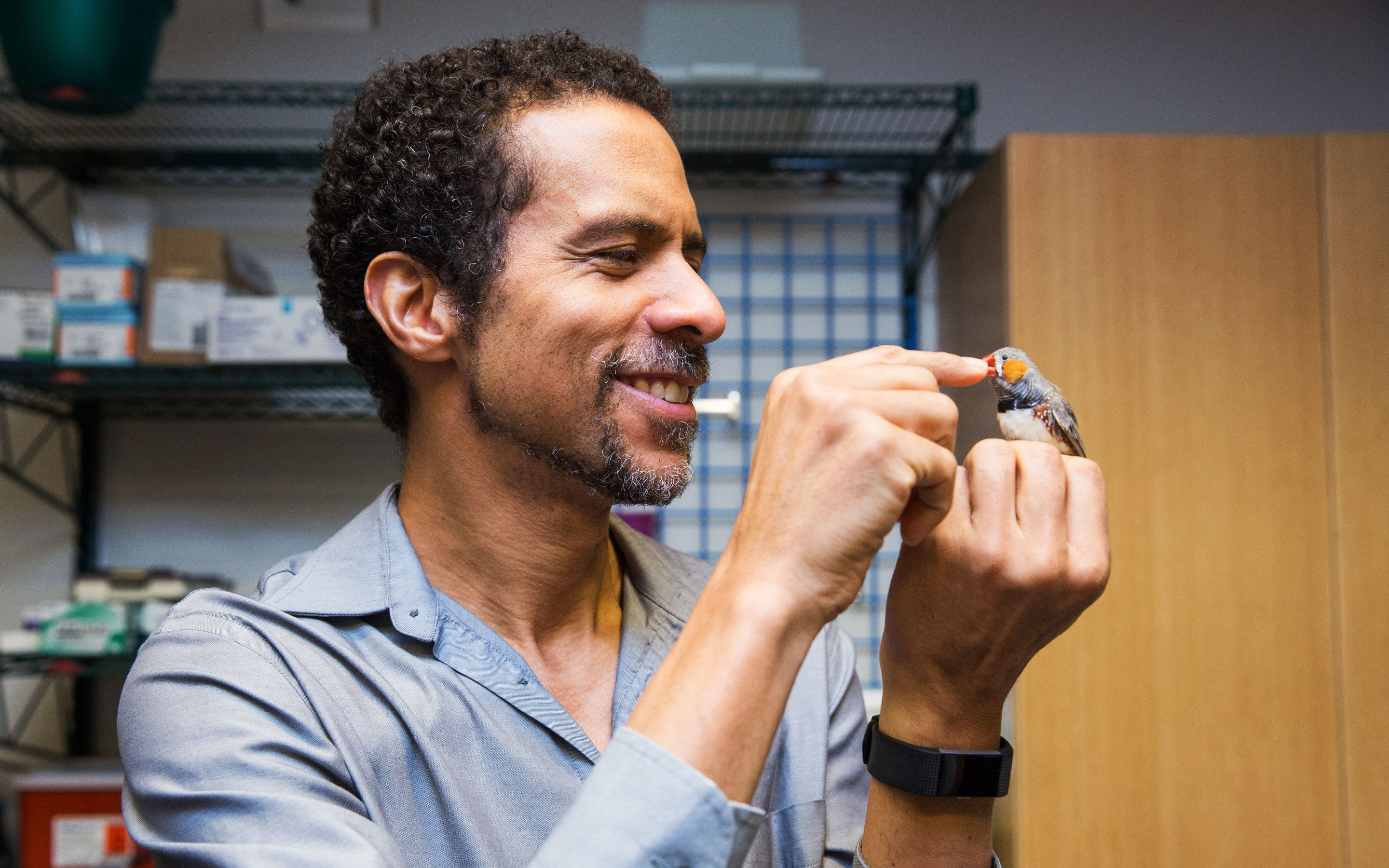 Lede photo of Jarvis holding a zebra finch