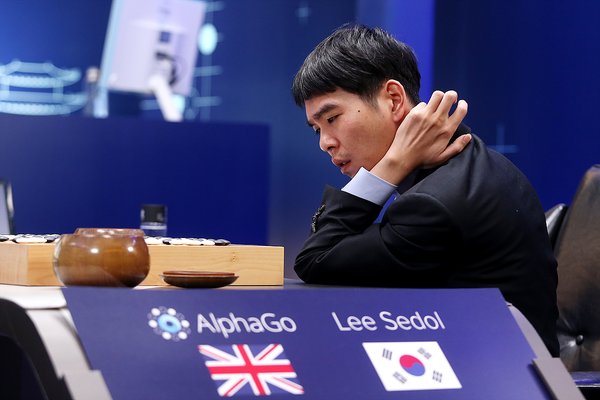 Photo of Go champion Lee Sedol playing against AlphaGo