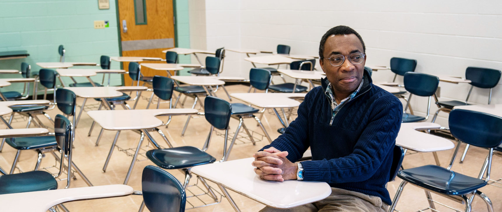 Photo of mathematician Donald Richards sitting in a Pennsylvania State University classroom.