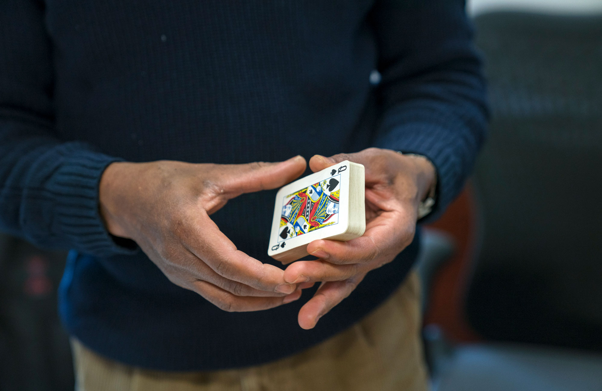 Photo of mathematician Donald Richards holding a deck of cards.