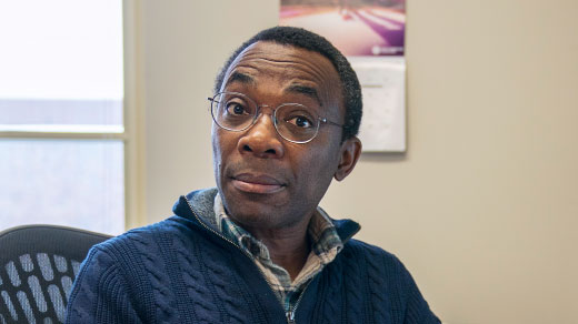 Photo of mathematician Donald Richards sitting in a Pennsylvania State University classroom.