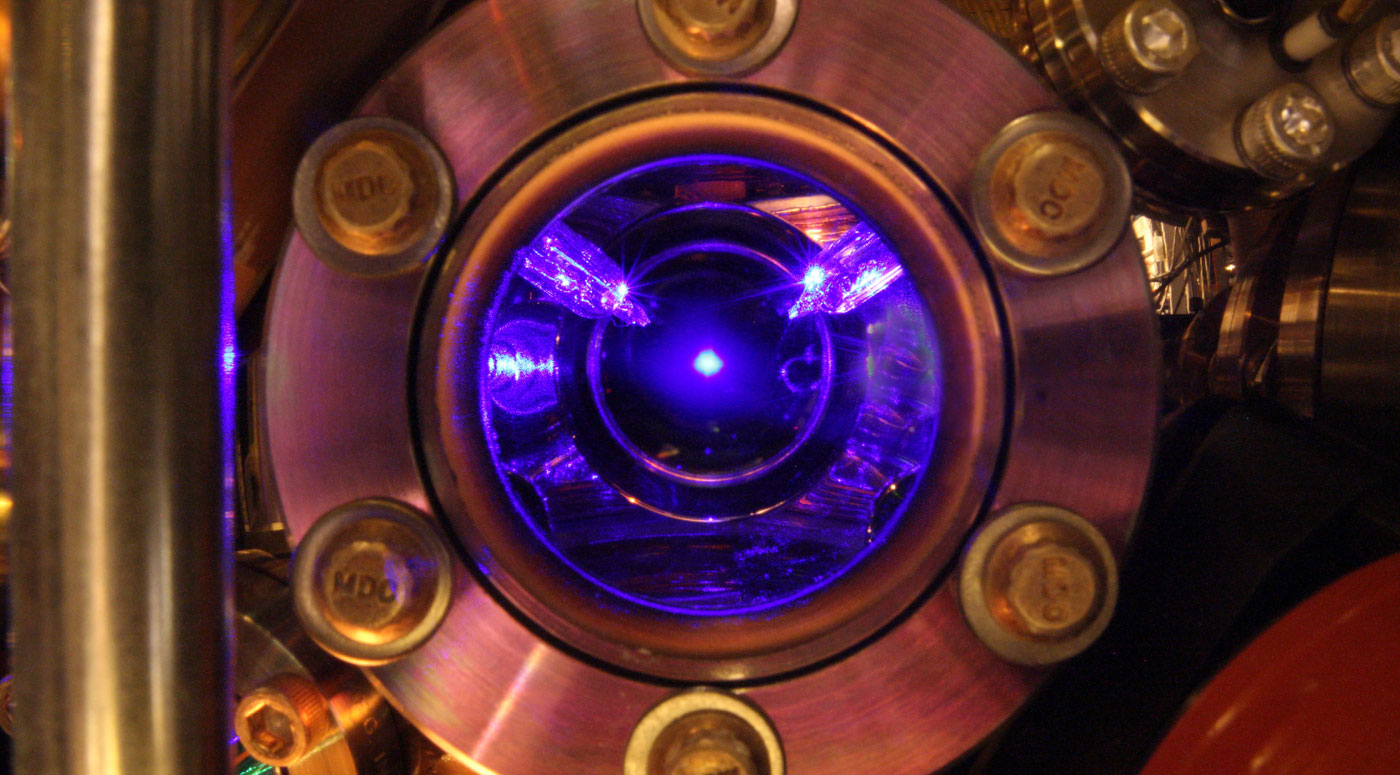 Photo looking into the vacuum chamber from one of the viewports, the collection of cold Sr atoms is visible in the center, and the calibrated thermal sensors can also be seen.