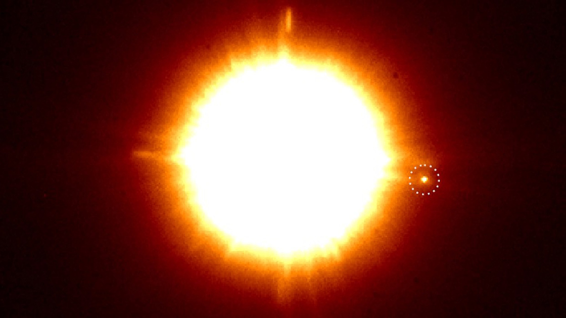 An infrared image of the binary star system CS Cha, taken by the SPHERE instrument on the European Southern Observatory's Very Large Telescope in Chile. The newly discovered companion is in the dotted circle.