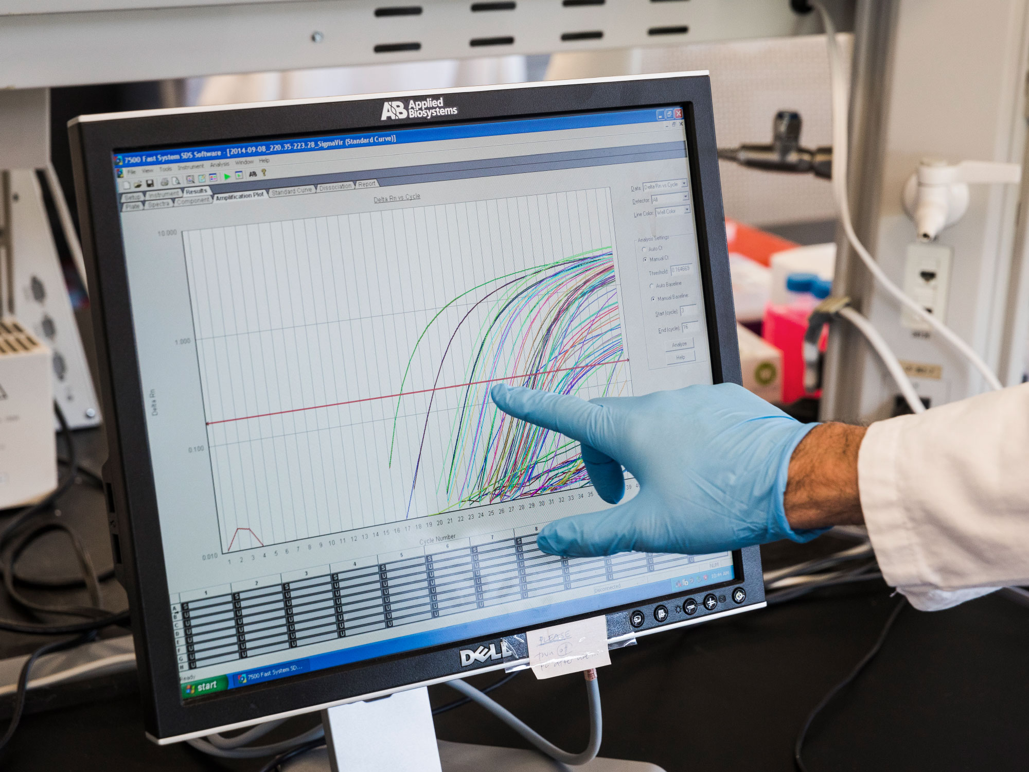 Photo of a researcher pointing at a monitor.