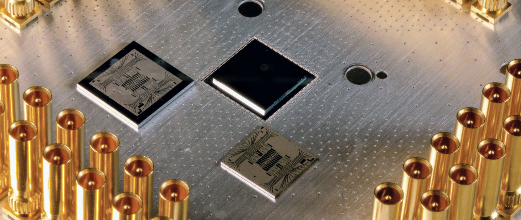 Photo of a silver metal plate with chips mounted on its surface.