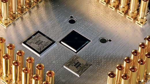 Photo of a silver metal plate with chips mounted on its surface.