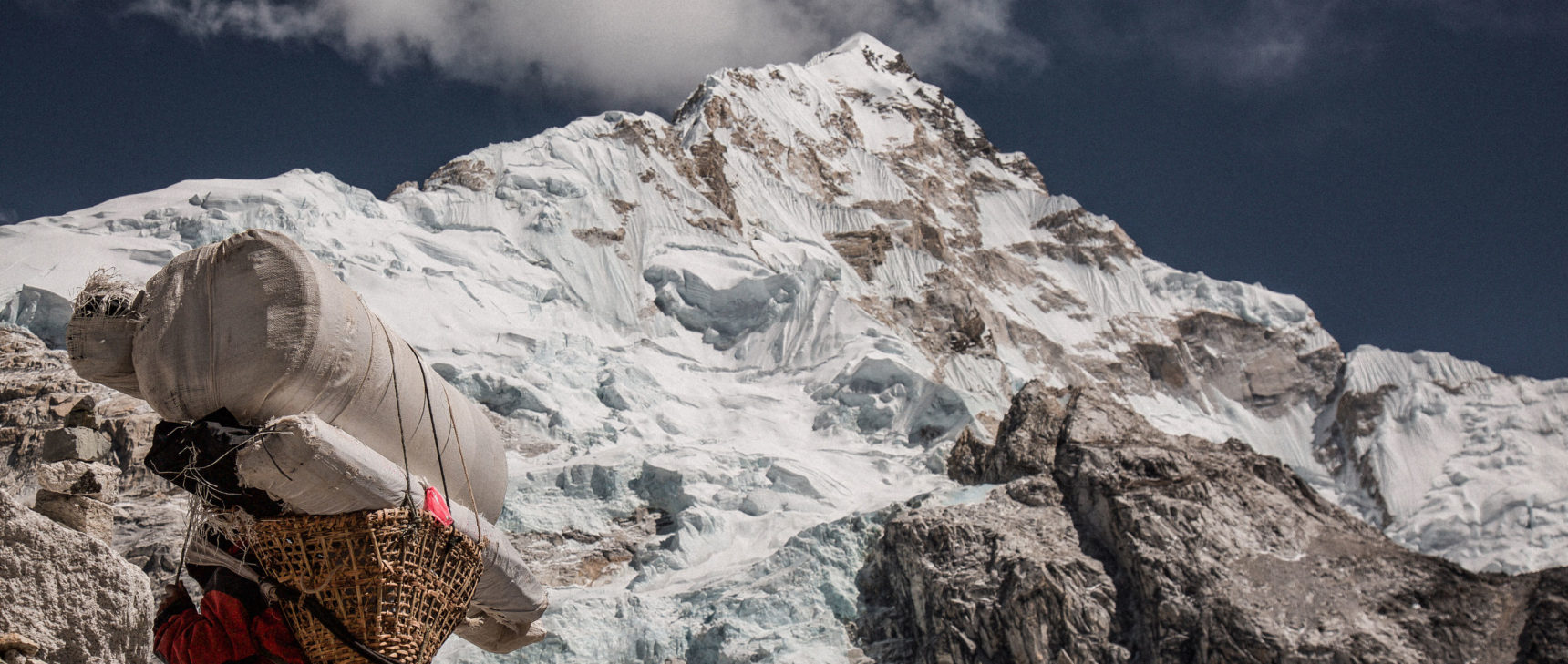 Climbing up the side of a high mountain peak.