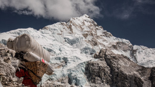 Climbing up the side of a high mountain peak.