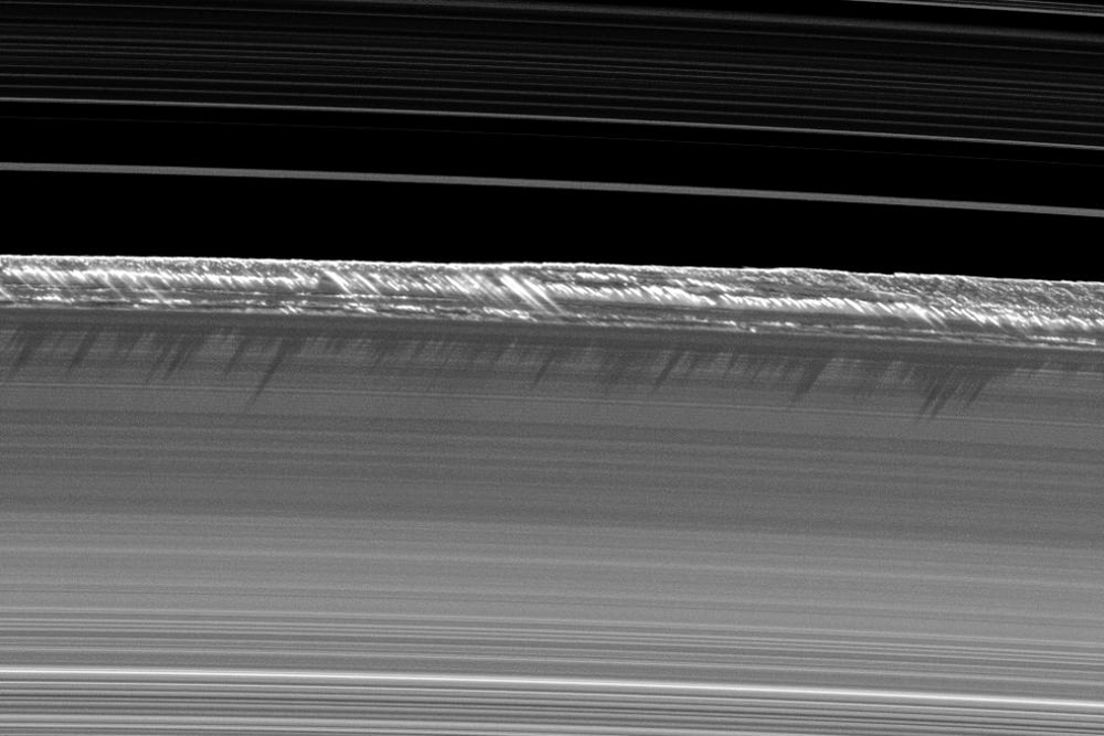 Vertical structures peeking out over Saturn’s rings.