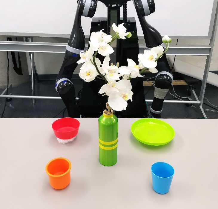 A robot arranging things on a table.