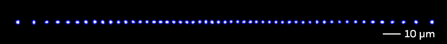 A line of individual atoms as glowing blue dots.