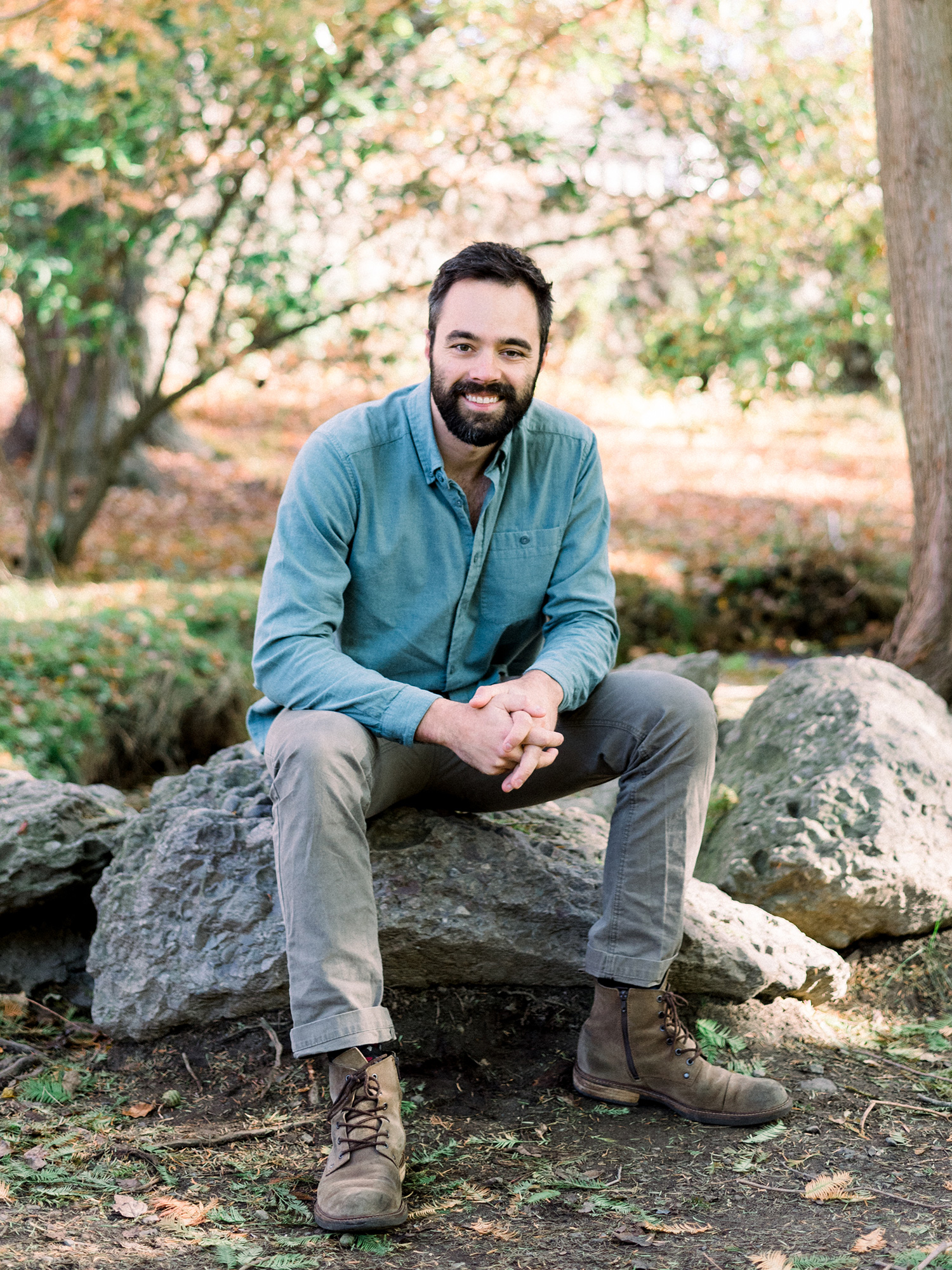 Photo of Samuel Punshon-Smith sitting on a rock outdoors