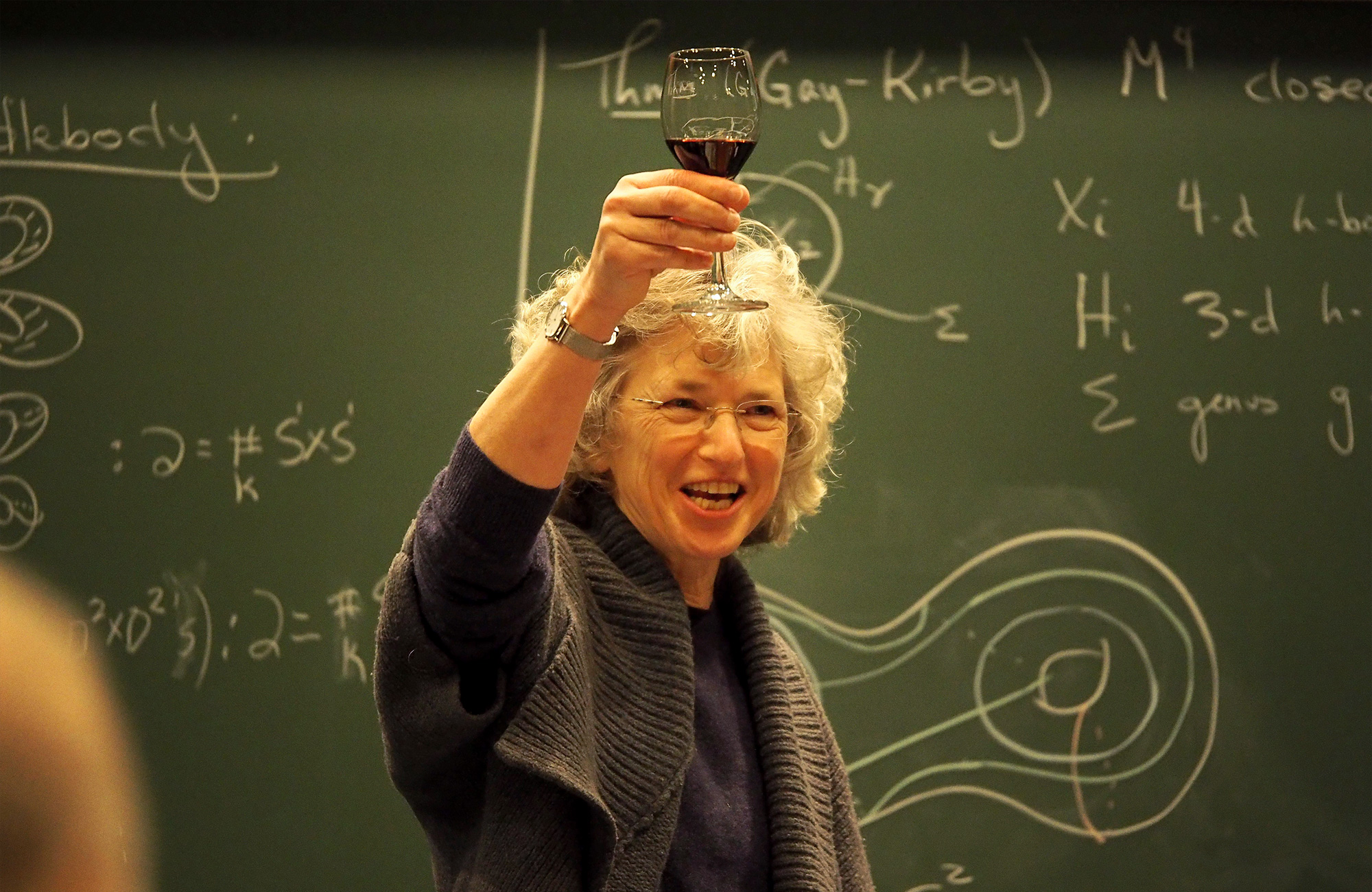 Photo of Abigail Thompson holding a wine glass during a talk