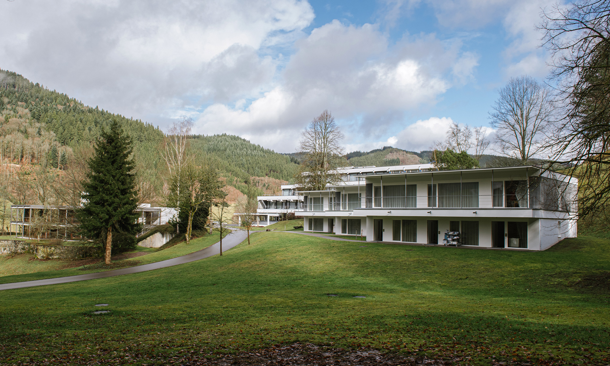 Photo of Oberwolfach buildings set against green hills and trees