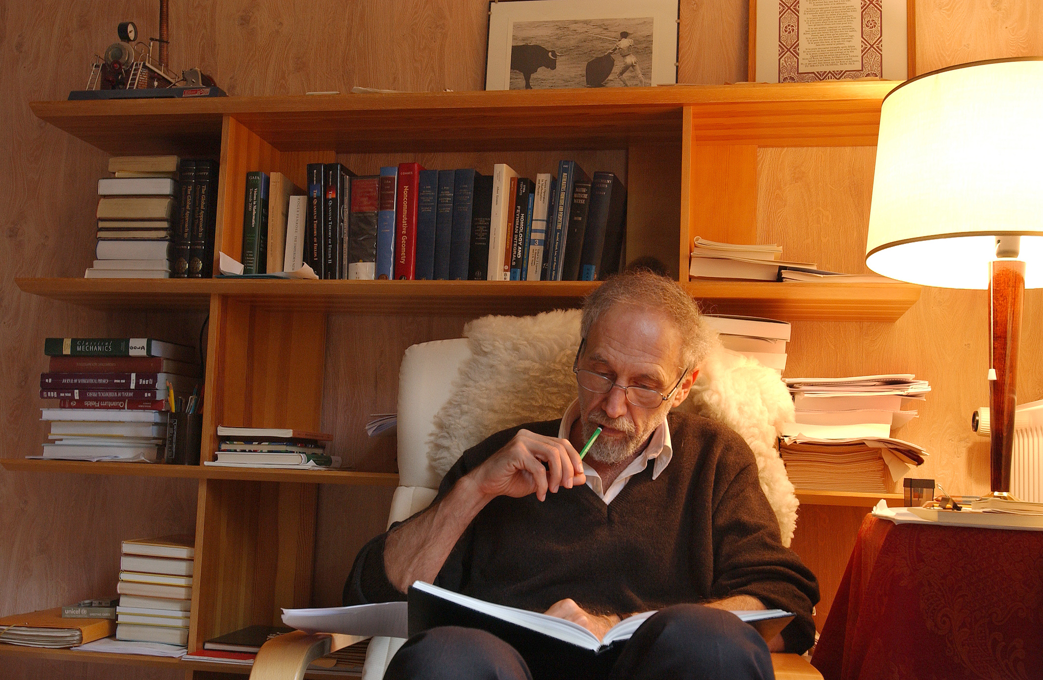 Photo showing Alain Connes working in an office