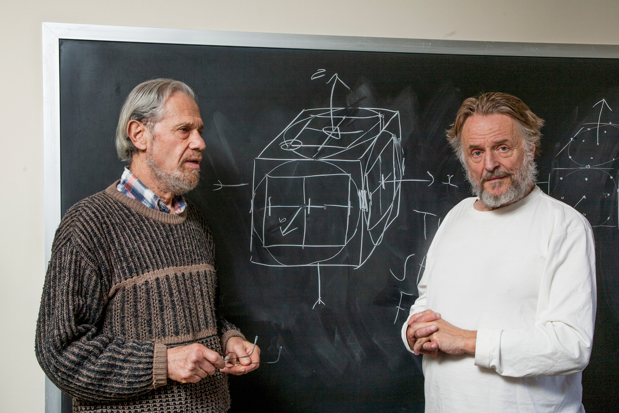 Photo of John Conway and Simon Kochen in front of a chalkboard