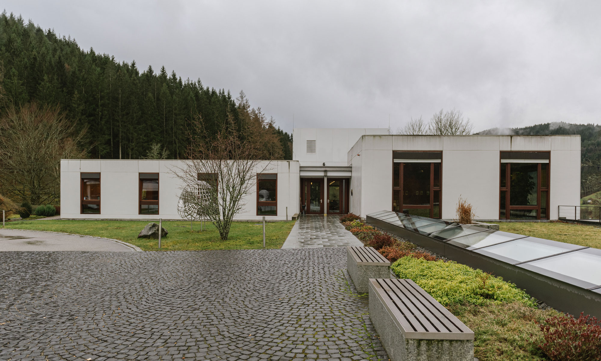 Exterior photo of the main building of the Oberwolfach Research Institute for Mathematics on a cloudy day