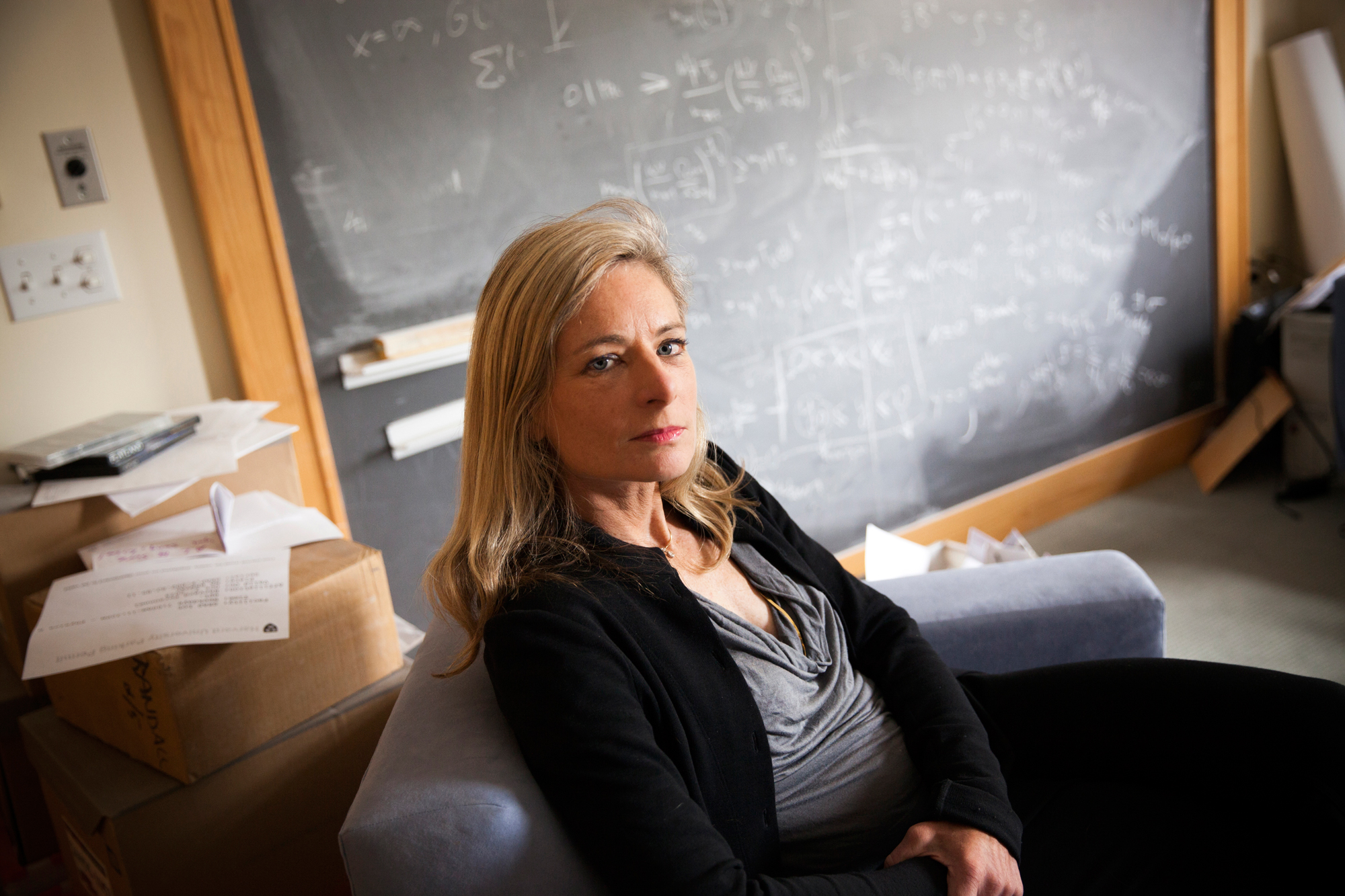 Lisa Randall framed by a blackboard in her office.