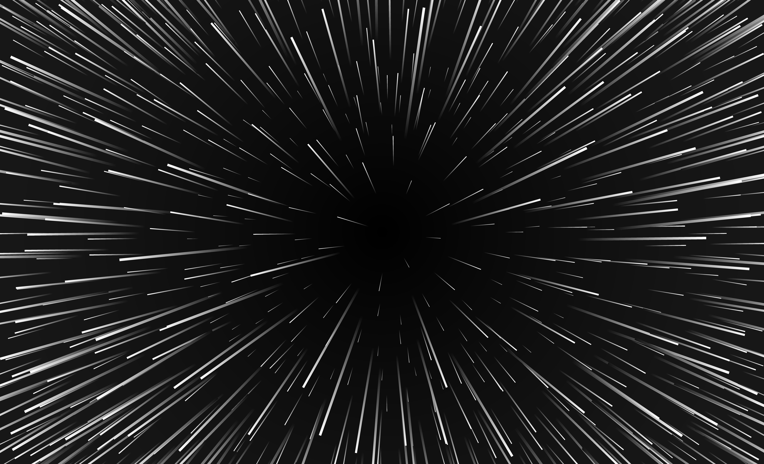 An image of space with lines emanating from a central point, as if the viewer is traveling at warp speed.