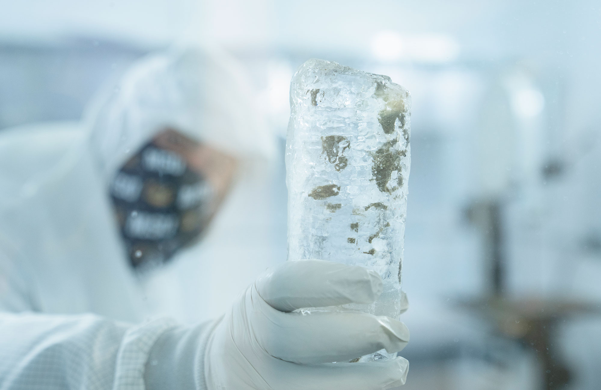 Piece of ice core being held in cold room.