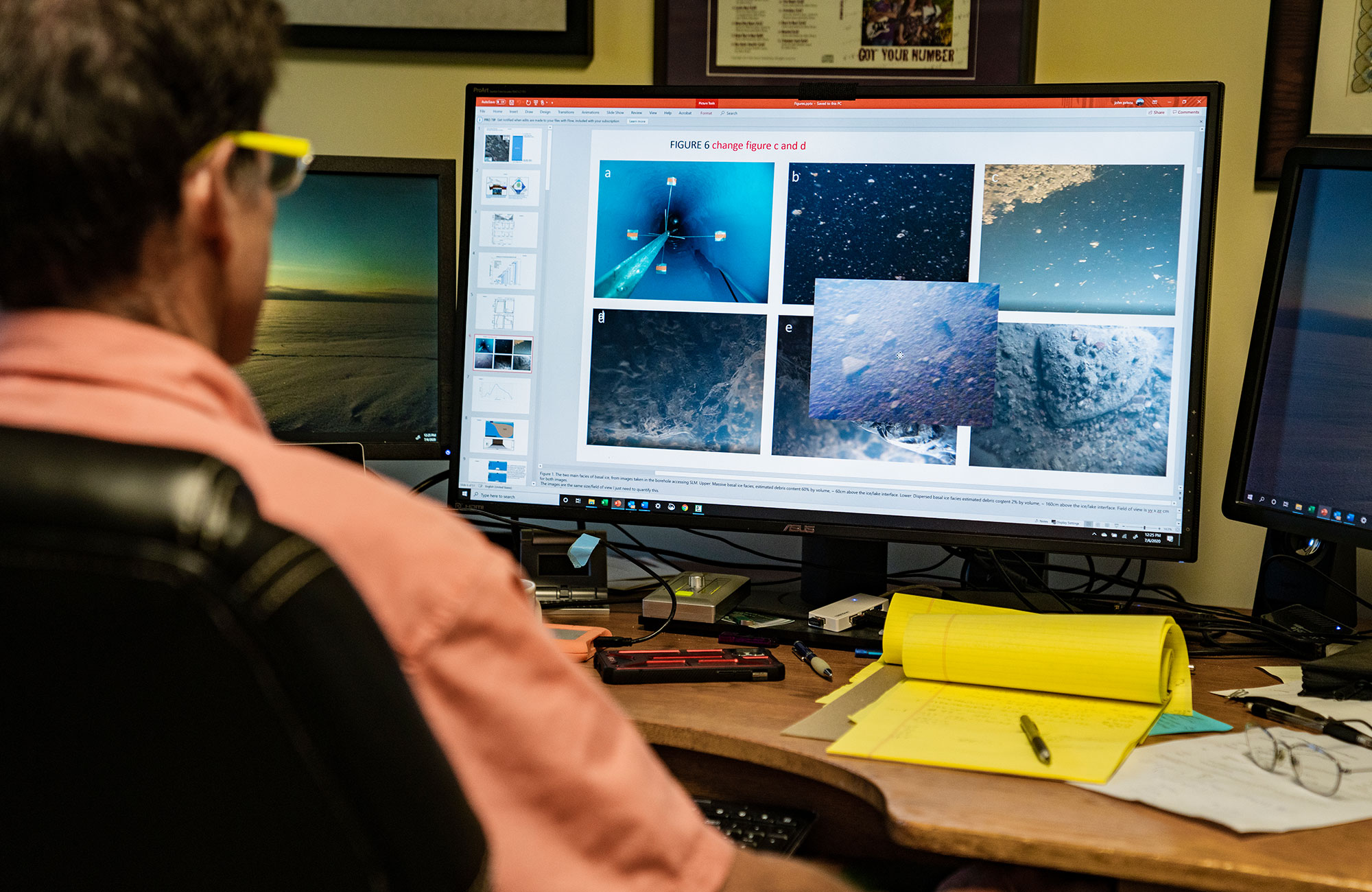 Priscu at computer, looking at several coring images on screen.