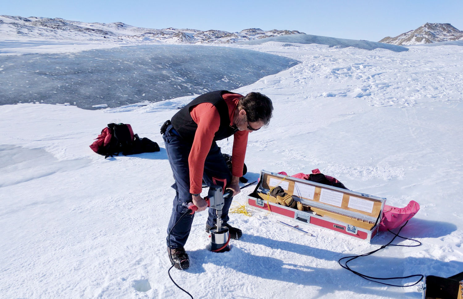 Priscu drills an ice core on Greenland ice sheet.