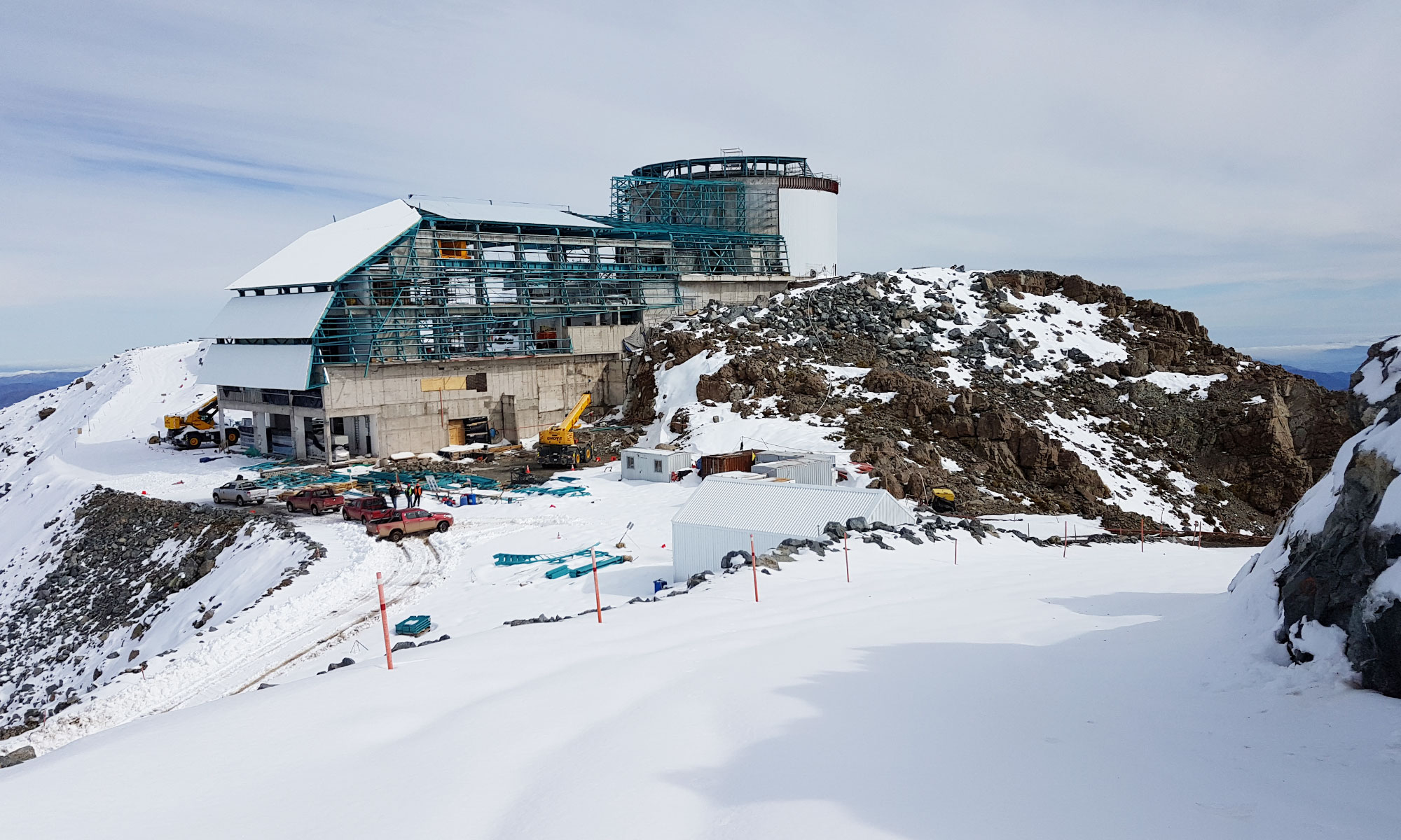 Photo of the Vera C. Rubin Observatory under construction on a snowy mountaintop.