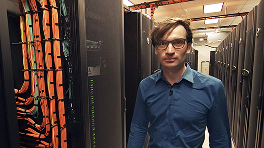 Photo of Marijn Heule walking among computer processors