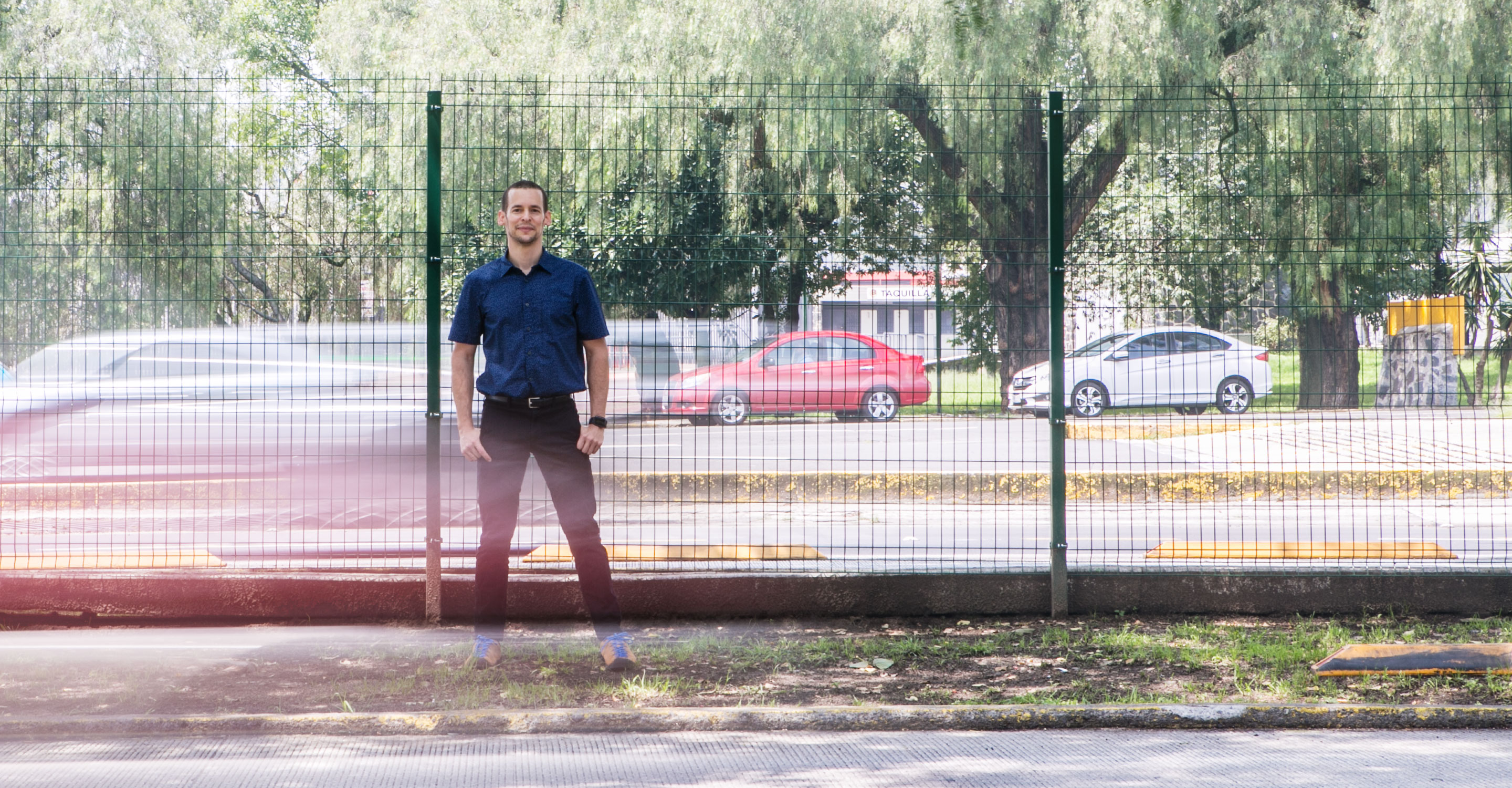 Computer scientist and complexity researcher Carlos Gershenson of the National Autonomous University of Mexico stands by a busy urban roadway.