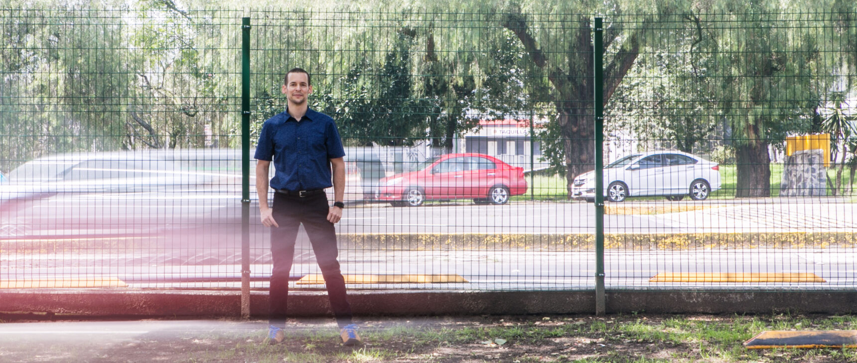 Computer scientist and complexity researcher Carlos Gershenson of the National Autonomous University of Mexico stands by a busy urban roadway.