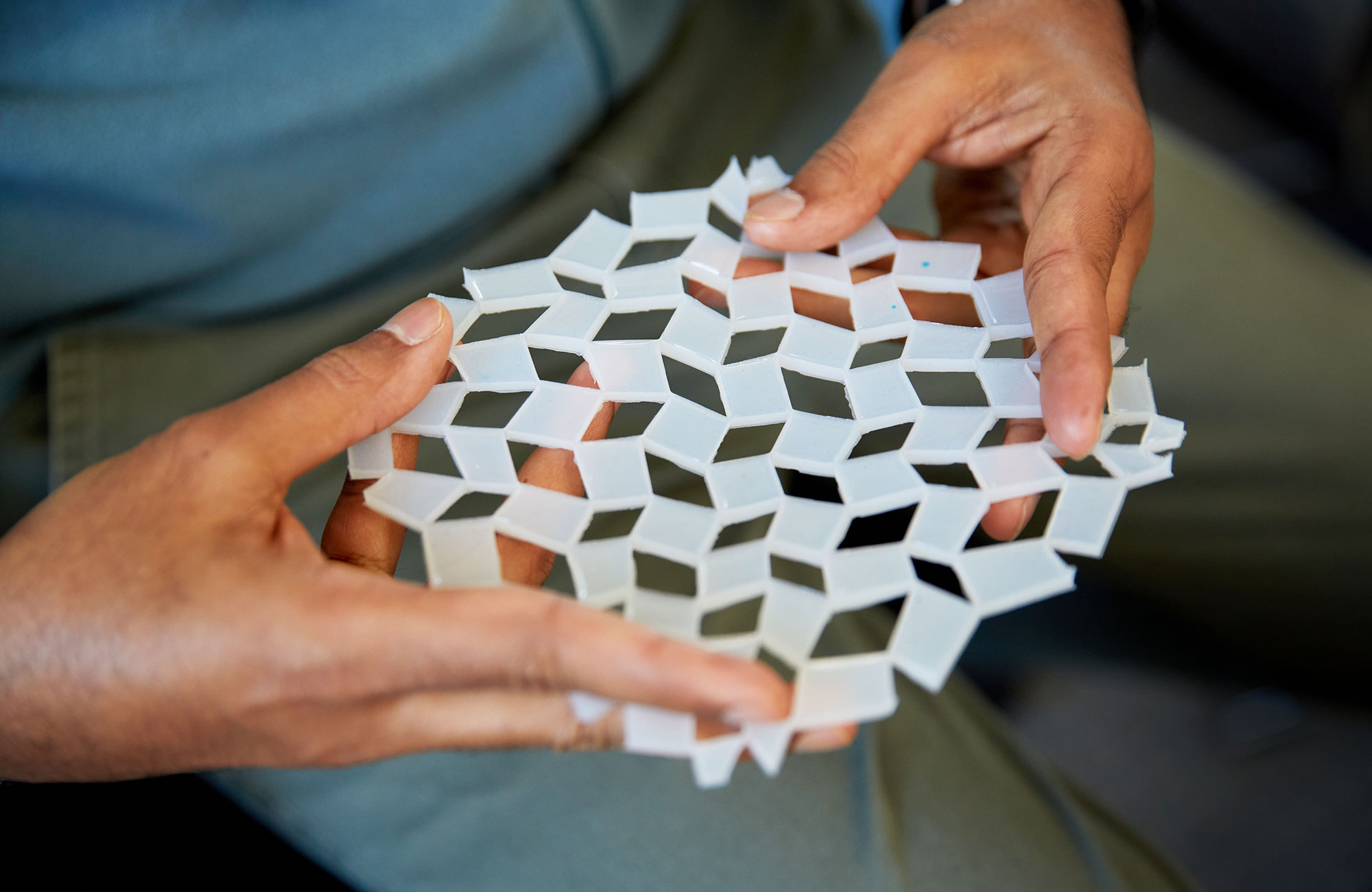 Mahadevan holds a white molded gel that reflects the cuts of kirigami