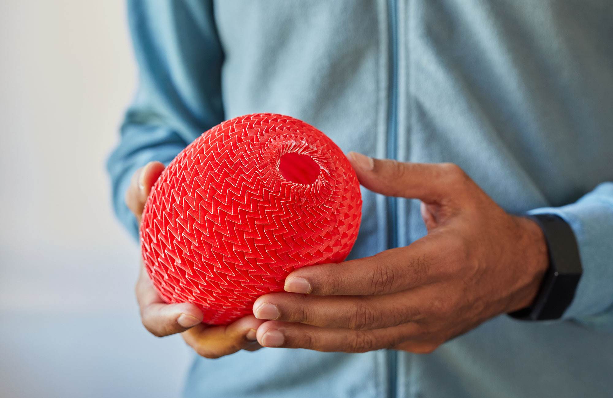 Mahadevan holds a red origami shape, made out of folded paper