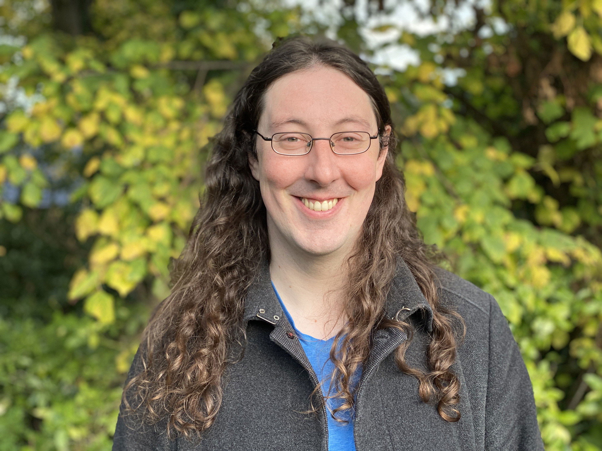 An outdoor photo of David Conlon with a leafy background