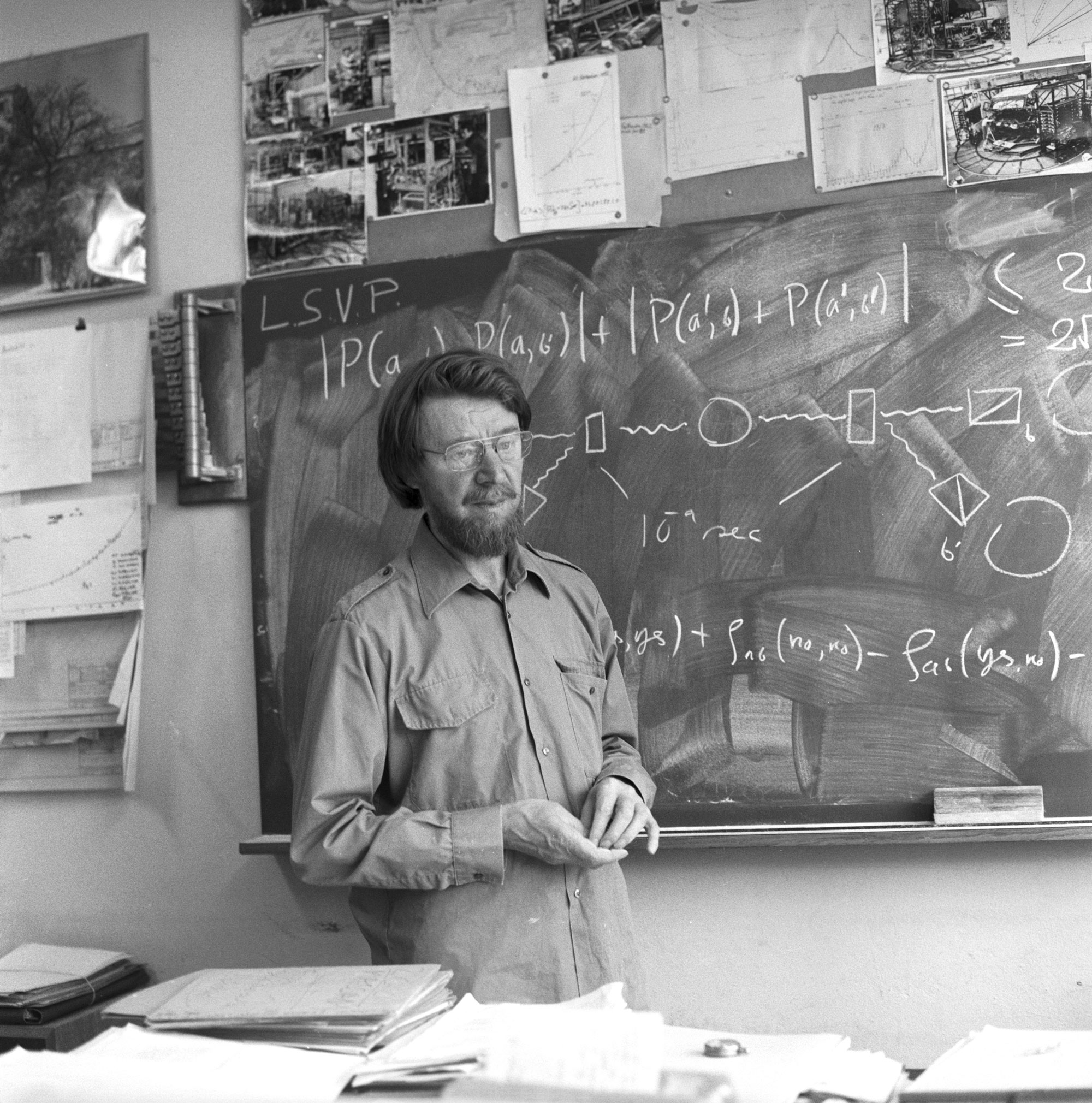 John Stewart Bell standing at a blackboard.