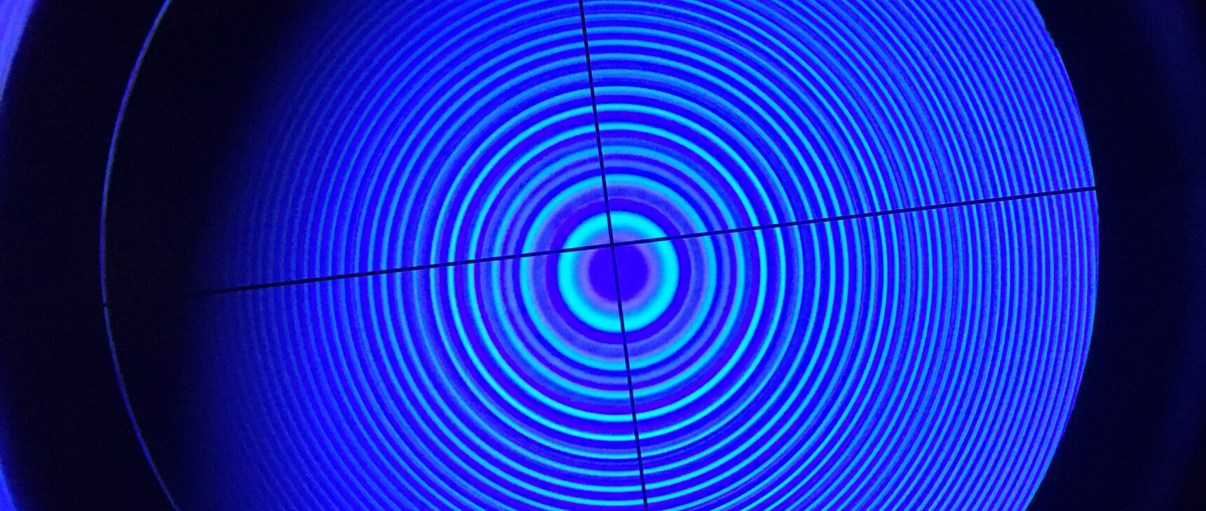 Concentric rings of light seen through crosshairs of a Fabry-Pérot interferometer.