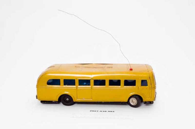 a closeup photo of a remote-controlled yellow bus he built