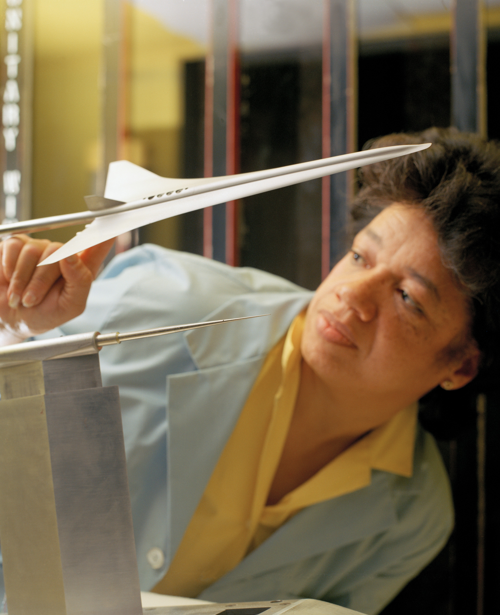 Historical photo of Darden examining a model plane in a NASA lab