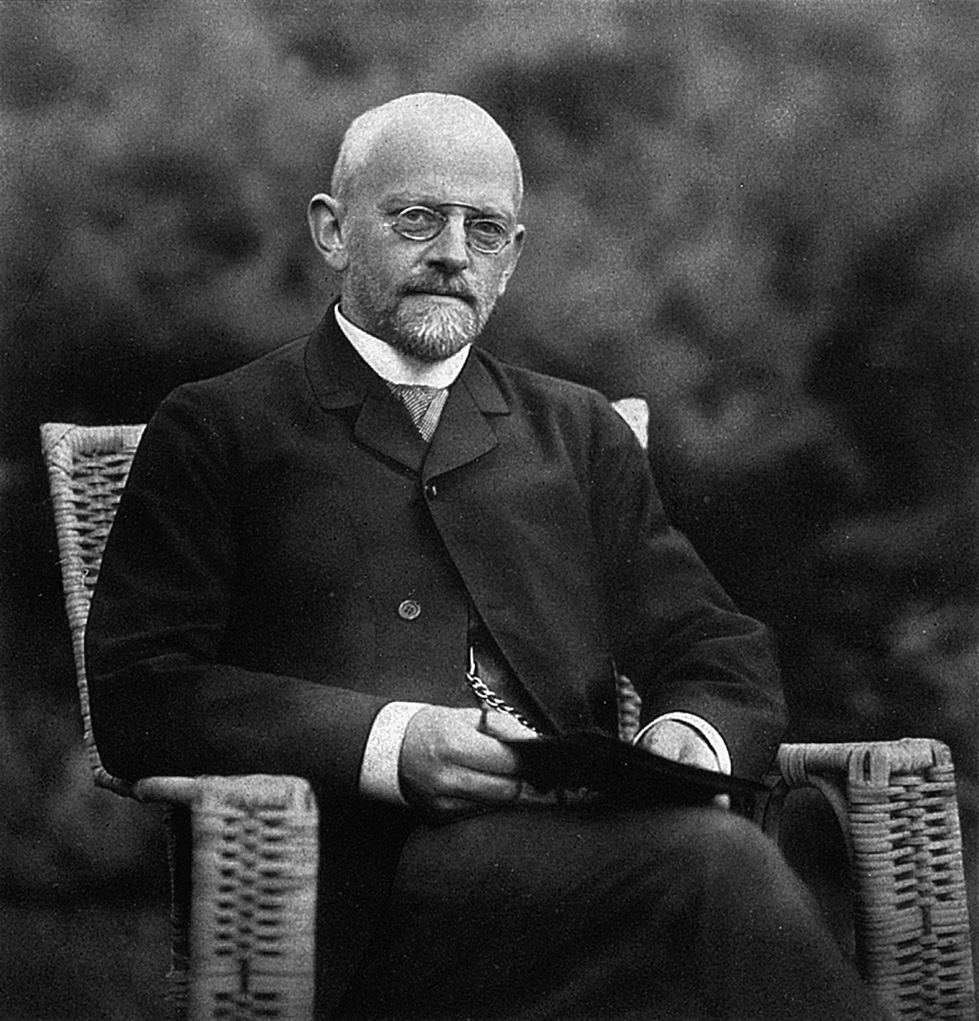 Historical photo of David Hilbert sitting in a chair outdoors.