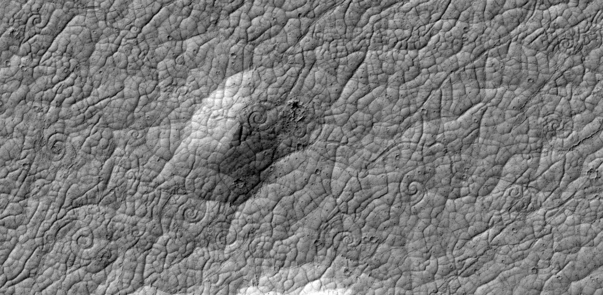 Grey images of Mars’ surface showing lava flows.