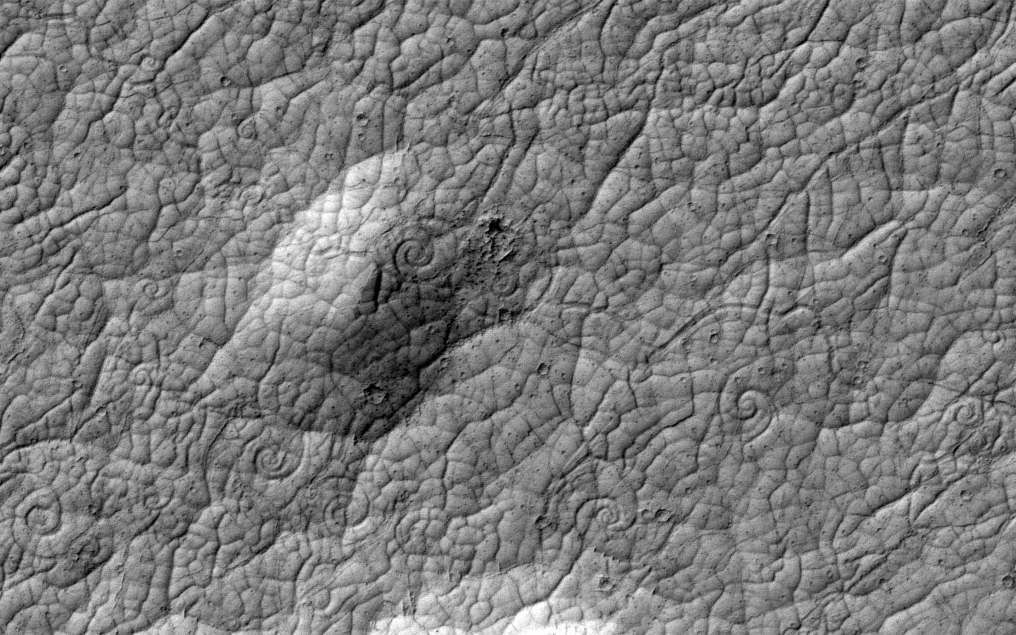 Grey images of Mars’ surface showing lava flows.