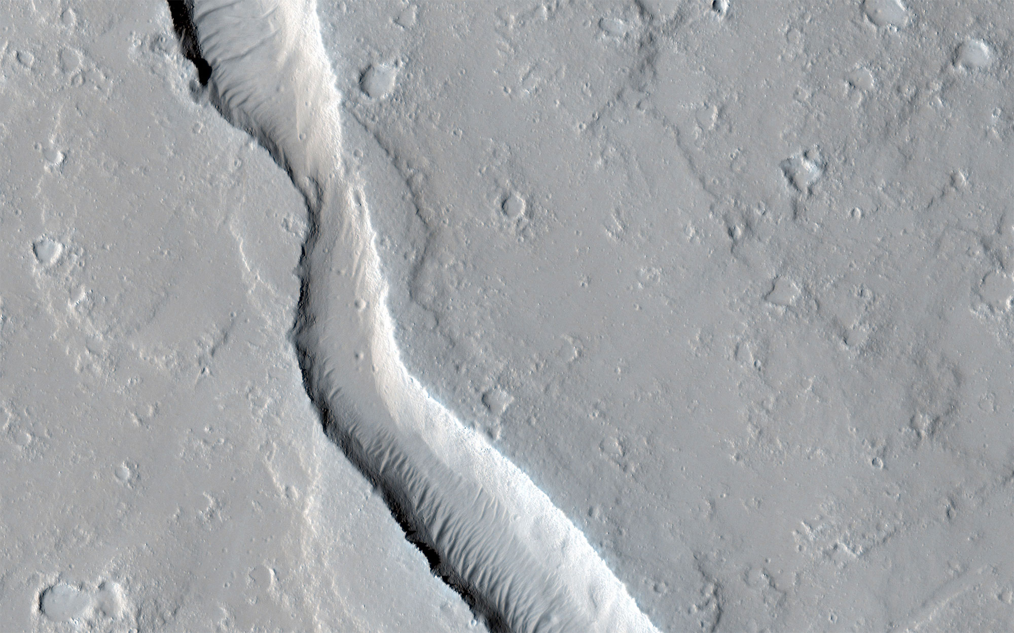 Grey images of Mars’ surface showing lava flows.