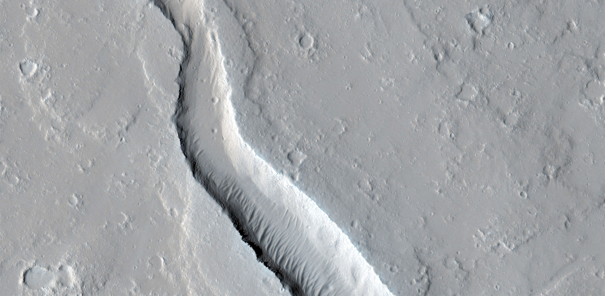 Grey images of Mars’ surface showing lava flows.