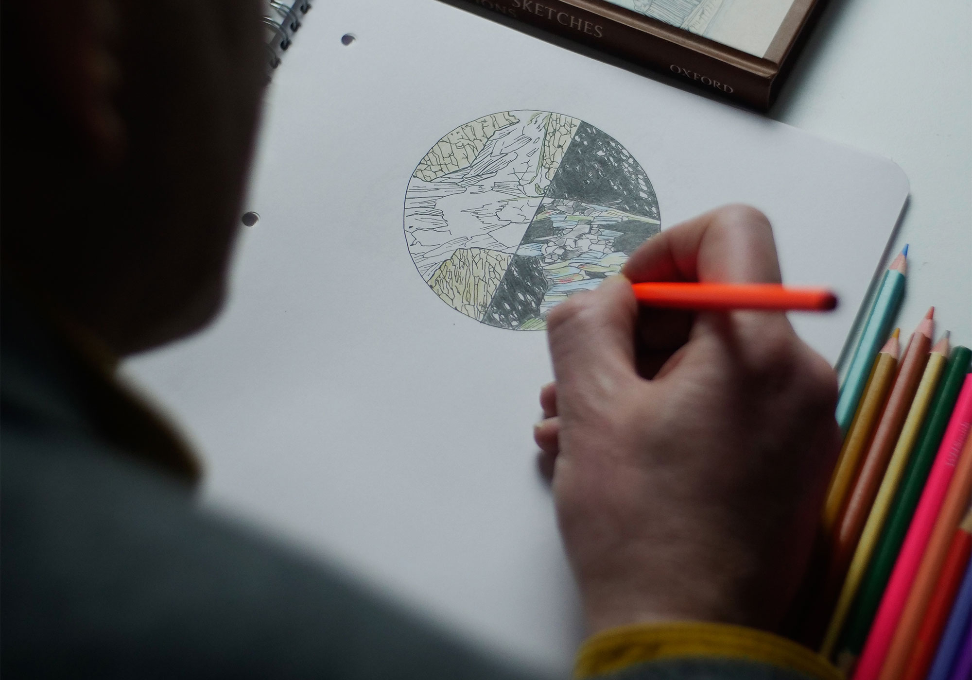 Matt Genge draws a circular slice of rock.