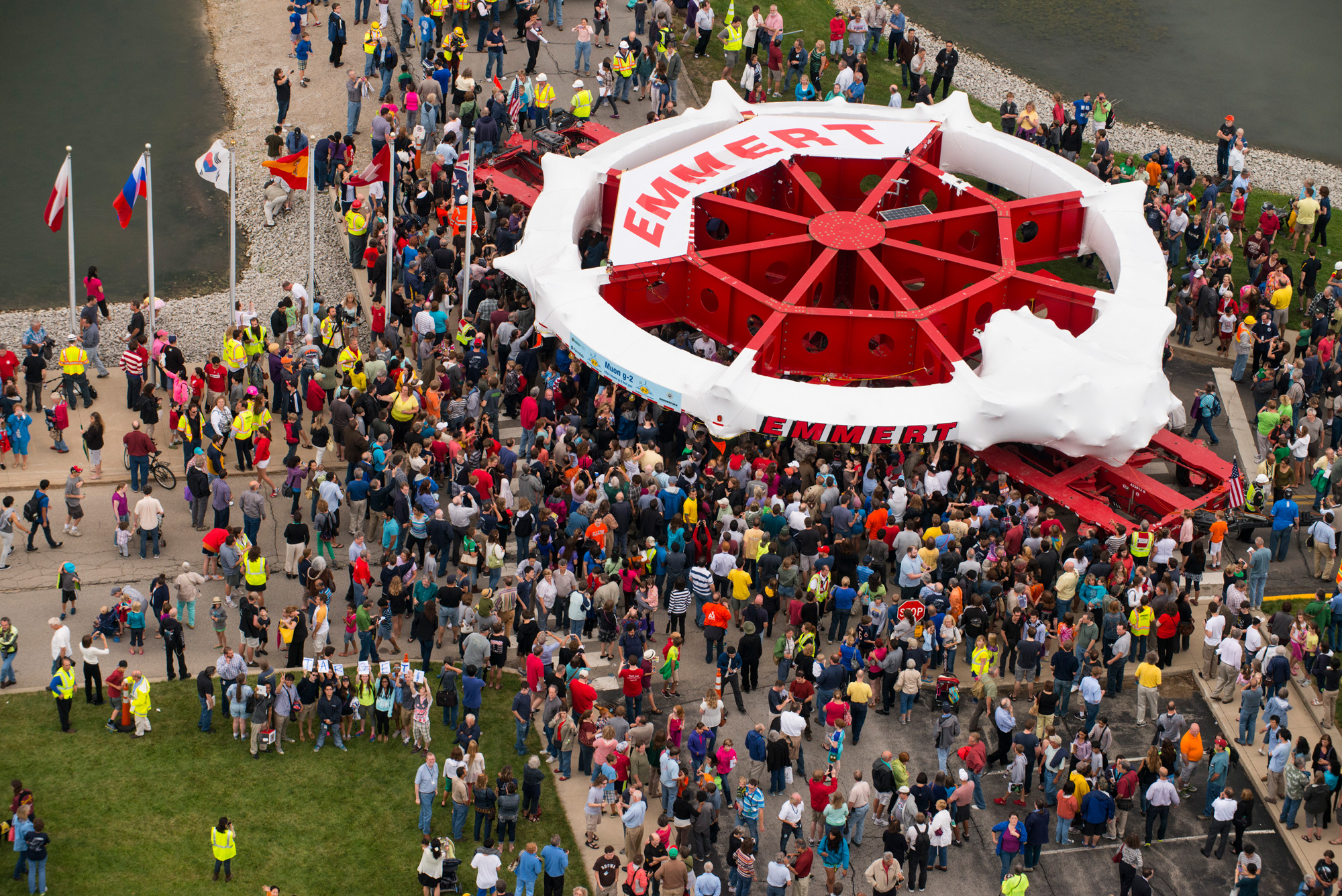 A throng of people around a red 50-foot-wide circular ring.