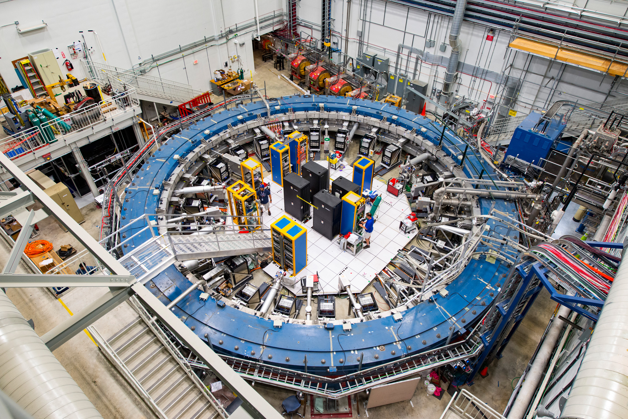 Overhead view of a large circular steel ring with lots of wires and experimental equipment.