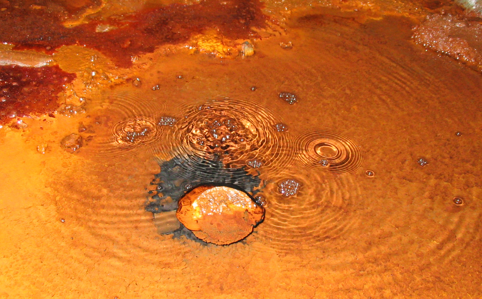 Gas bubbling through a puddle in the Soudan Mine.